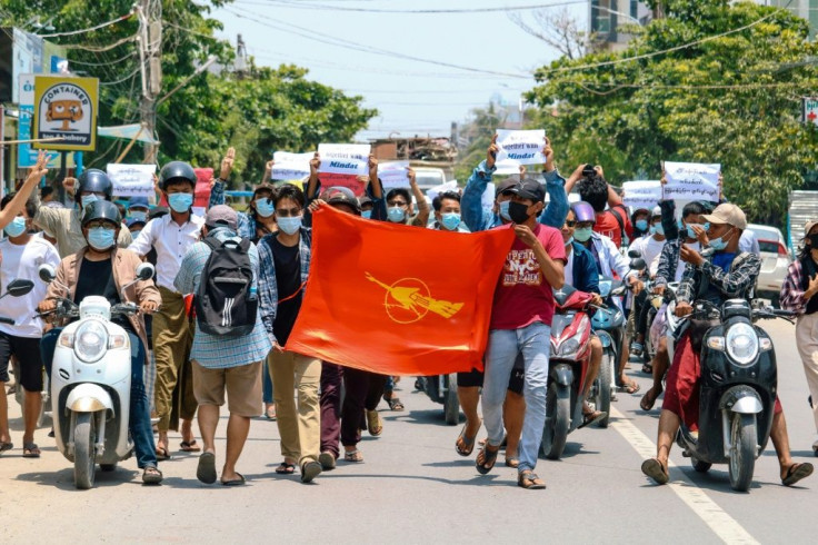 Protesters hold the Myanmar Student Union flag during a demonstration against the military coup in Mandalay