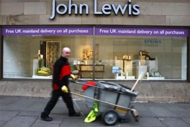 A road cleaner walks past a John Lewis store in Edinburgh, Scotland