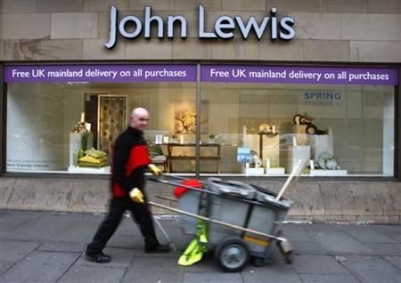 A road cleaner walks past a John Lewis store in Edinburgh, Scotland