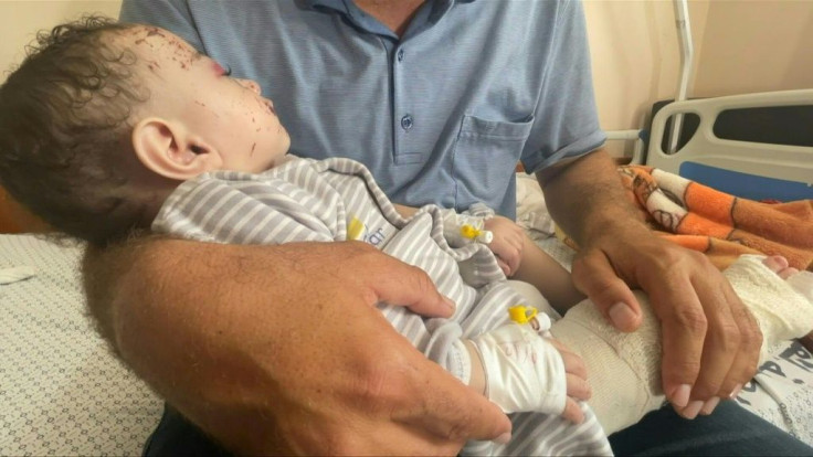 Inside a Gaza hospital, Mohammad al-Hadidi cradled his baby boy Omar -- his only surviving child after Israeli air strikes killed his wife and four other sons in the night. After the strikes, rescue workers pulled the five-month-old from the arms of his d