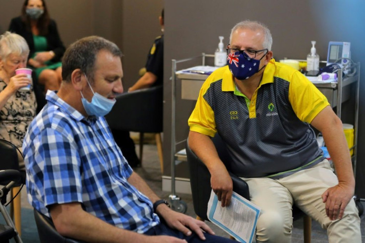 Australia's Prime Minister Scott Morrison (R) has defended his pandemic border policy