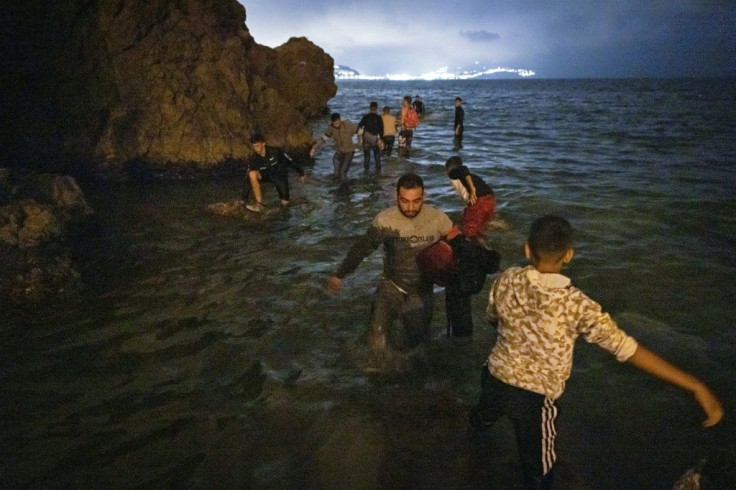 One migrant drowned as hundreds attempted to swim or wade along the coast to reach Spanish soil in Ceuta