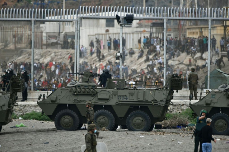 Spanish soldiers and Guardia Civil officers stand guard after some 6,000 migrants entered the Spanish enclave of Ceuta from Morocco