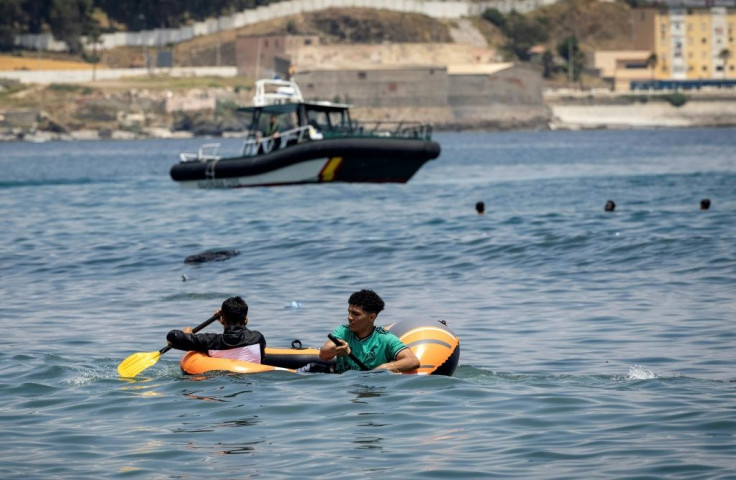 The migrants reached Ceuta by swimming or by walking at low tide from Moroccan beaches, some using rubber dinghies