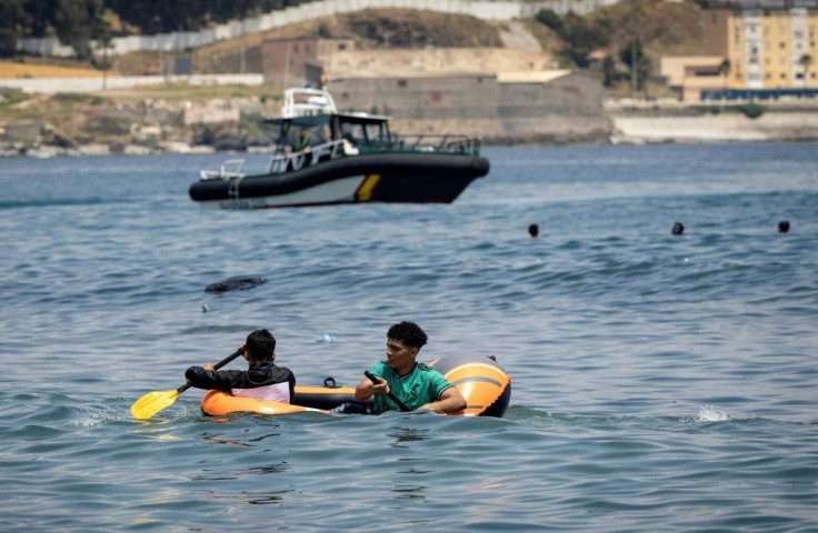 The migrants reached Ceuta by swimming or by walking at low tide from Moroccan beaches, some using rubber dinghies