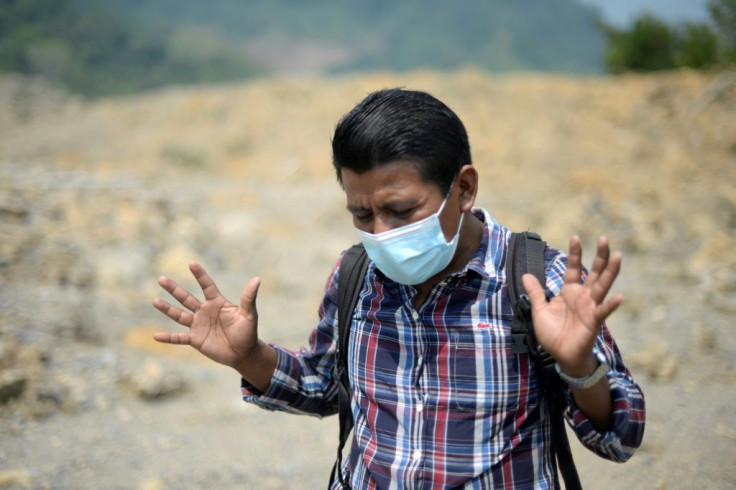 German Cal Pop is seen in the Guatemalan village of Queja, which was destroyed by a landslide caused by heavy rains from the hurricanes that hit Central America