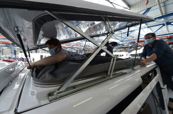 Hundreds of workers pierce and cut into Fiat and Renault vans to add beds, kitchens, bathrooms and sky roofs to the vehicles at a factory of the Pilote company in the western French city of Angers