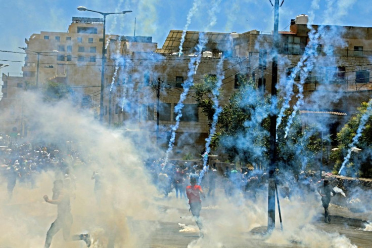 Israeli troops fire tear gas towards demonstrators during a protest in the West Bank town of Bethlehem
