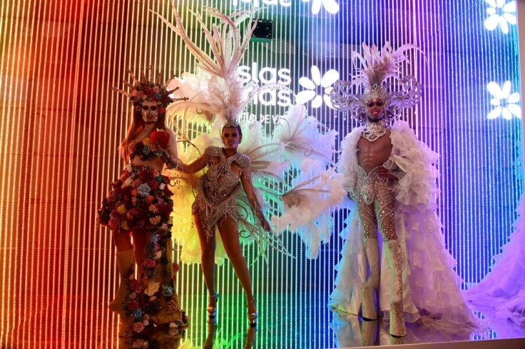 Models dressed for the Canary Islands carnival perform at the International Tourism Fair in Madrid