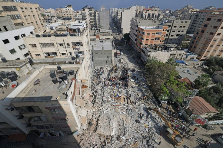 Palestinian rescue teams search for survivors under the rubble of a destroyed building in Gaza City's Rimal residential district on May 16
