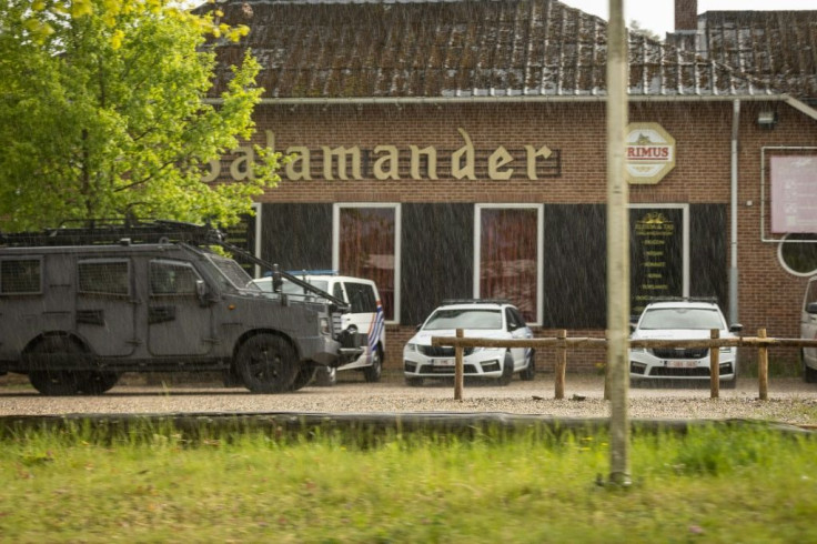 Belgian special forces pass the entrance of National Park Hoge Kempen as they hunt for a heavily armed soldier on the run