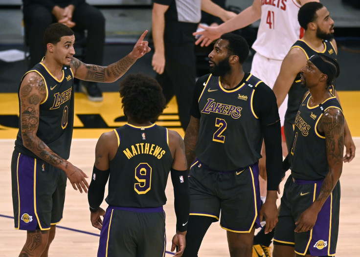 Kyle Kuzma #0 of the Los Angeles Lakers talks to Wesley Matthews #9 Andre Drummond #2 and Kentavious Caldwell-Pope #1 after a stop in play against the Houston Rockets