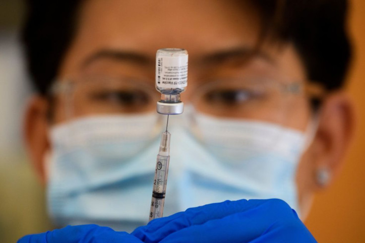 A health care worker prepares a dose of the Pfizer Covid-19 vaccine