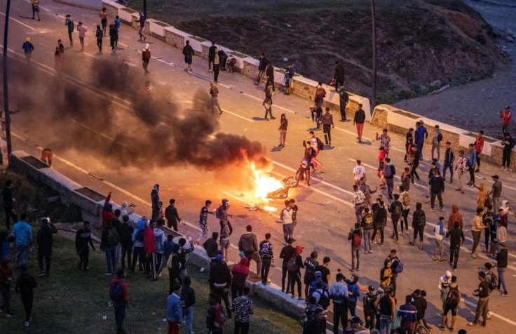 Migrants clashed with Moroccan forces guarding the border overnight Wednesday, as tensions rise between Madrid and Rabat