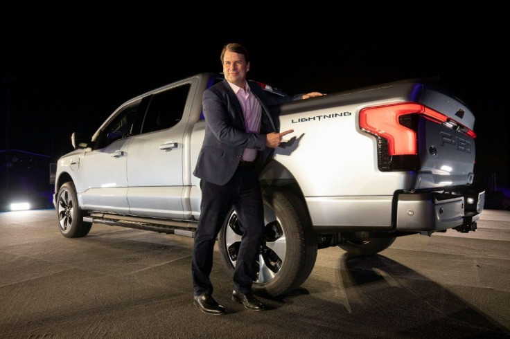 Jim Farley, CEO of Ford Motor Company, posed with the new all-electric F-150 Lightning at a reveal event Wednesday night