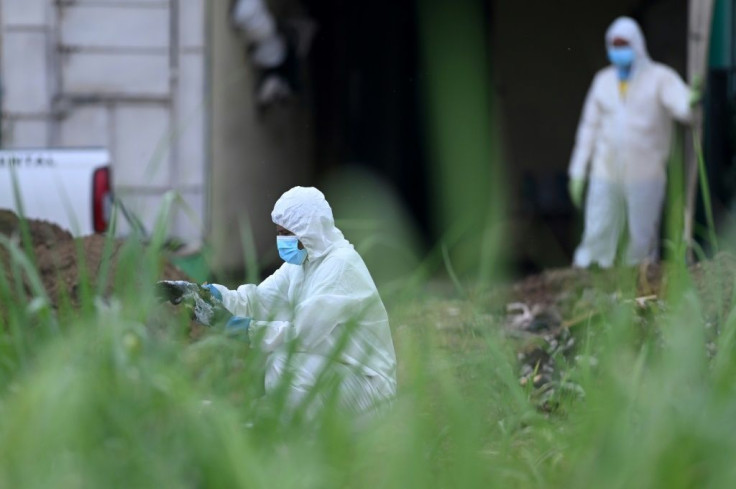 Authorities work at the home of former police officer Hugo Ernesto Osorio Chavez, suspcted of killing at least 14 people