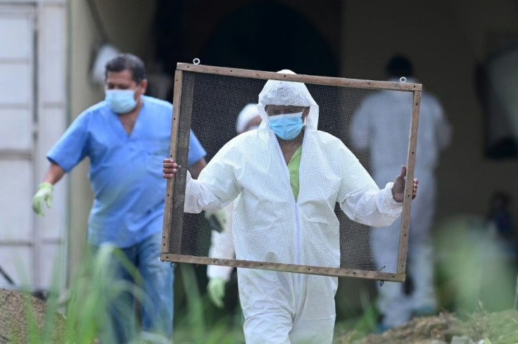 Clad in full biosafety gear, a team entered the home of ex-cop Hugo Ernesto Osorio Chavez, suspected of killing more than a dozen people