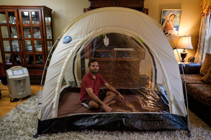 Akash Negi sits in a hypoxic tent, a low-oxygen tent that mimics thin air at high altitude, as he prepares for his Everest expedition