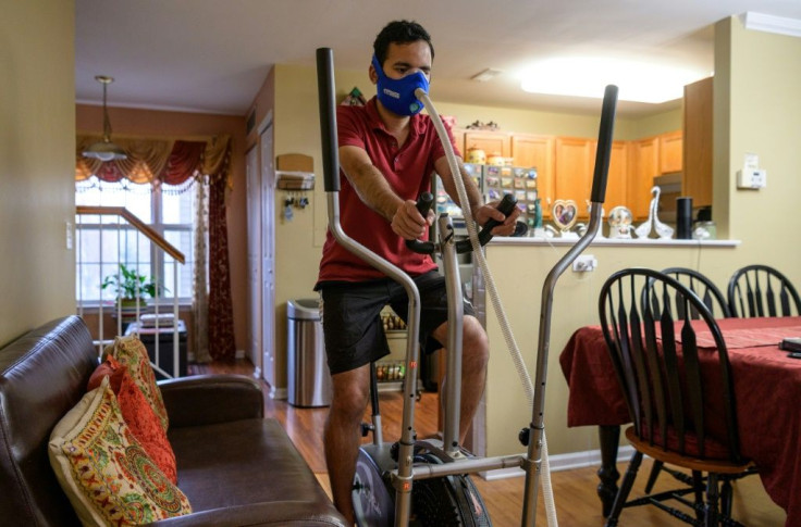Akash Negi trains with a face masks attached to a device that reduces his oxygen supply