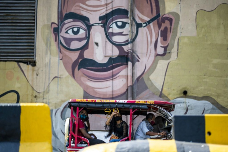 An auto-rickshaw driver transports passengers in Noida, India
