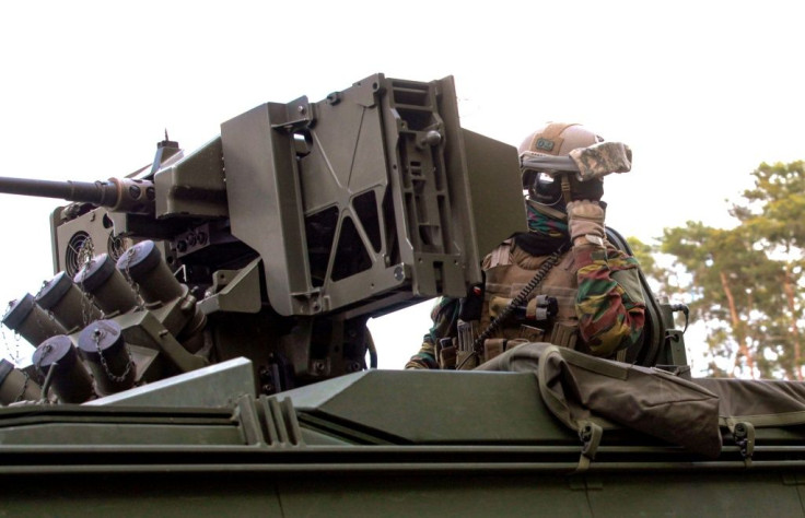 Belgian troops have deployed alongside special police units to track down a missing comrade with extremist views who has threatened to target virologists