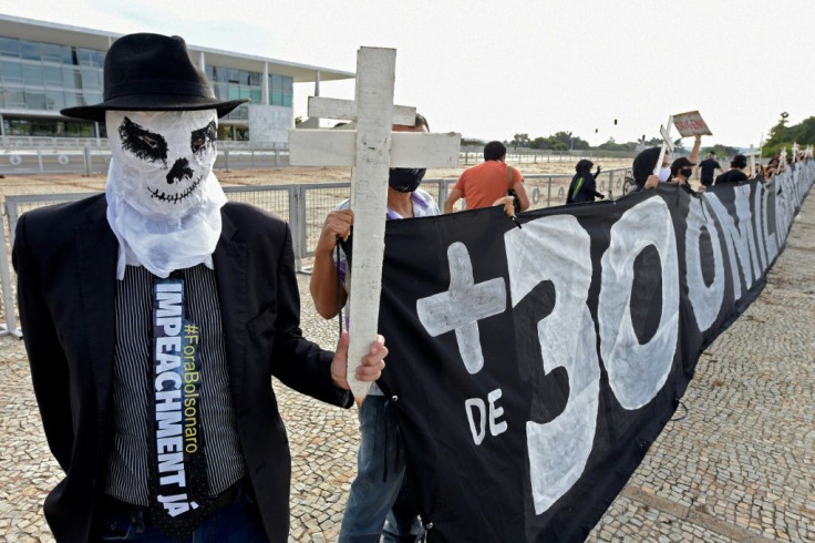 A demonstrator decries Brazil's high Covid-19 death toll as he protests against the government of President Jair Bolsonaro in Brasilia in March 2021