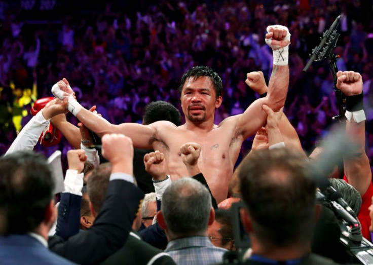 Manny Pacquiao, here celebrating his victory over Keith Thurman in 2019, says he'll return to the ring against Errol Spence in August 2021