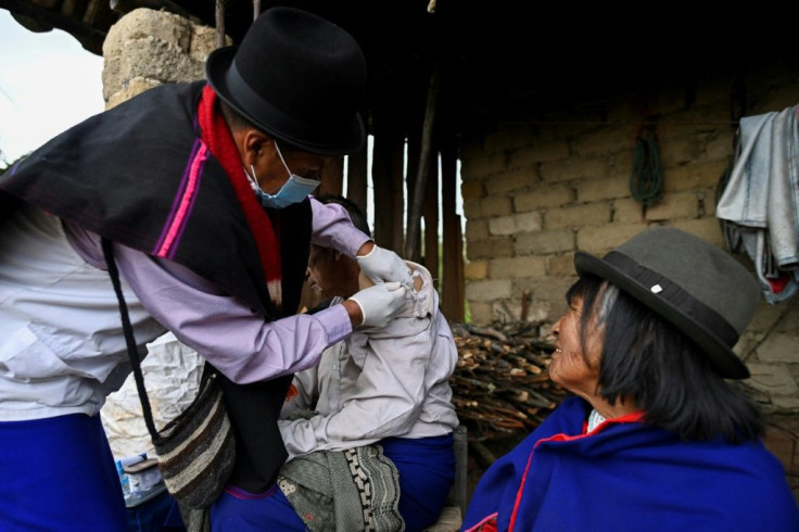 An indigenous nurse from the Misak ethnic group inoculates an elderly man with a Sinovac vaccine in Colombia's Cauca department in April 2021