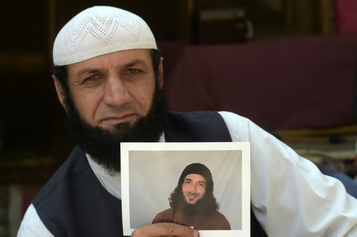 IAfghan refugee Roman Khan displays a photograph of his brother Asadullah Haroon Gul, who is detained in Guantanamo Bay detention camp.