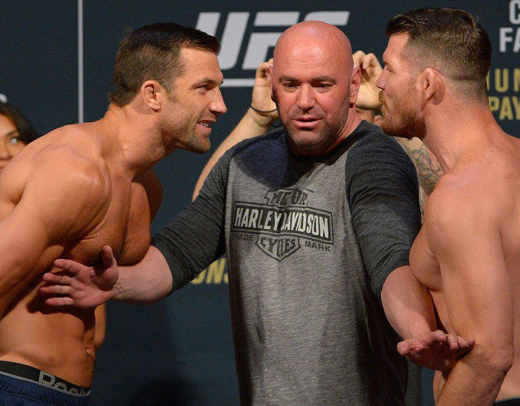 Middleweight champion Luke Rockhold and opponent Michael Bisping are separated by UFC President Dana White 
