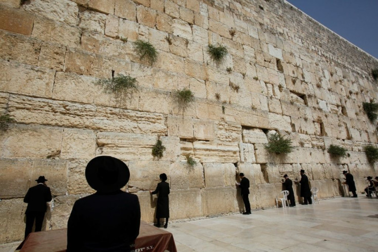 Ultra-Orthodox Jewish worshippers pray in front of the Western Wall in Jerusalem on May 21, 2021