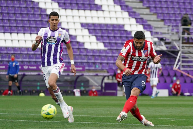 Winning moment: Atletico Madrid's Luis Suarez scores the title-clinching goal