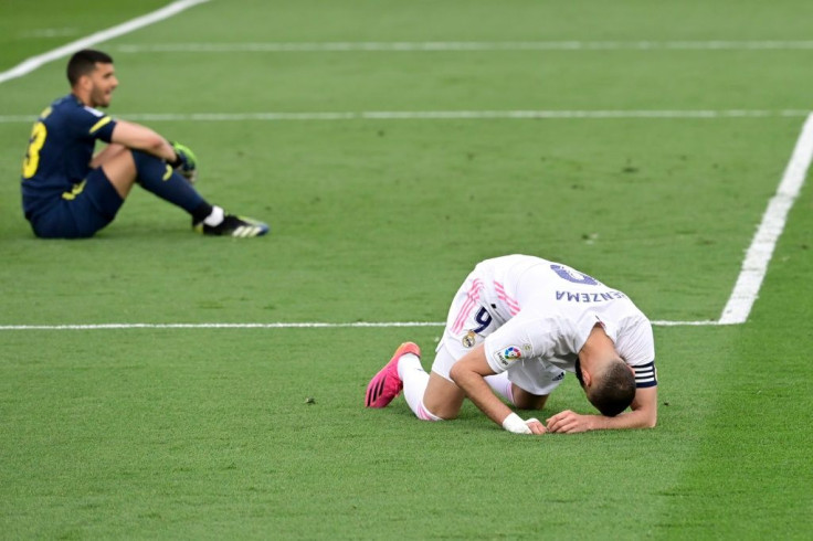 Shattered: Real Madrid's Karim Benzema is stunned after Atletico win title
