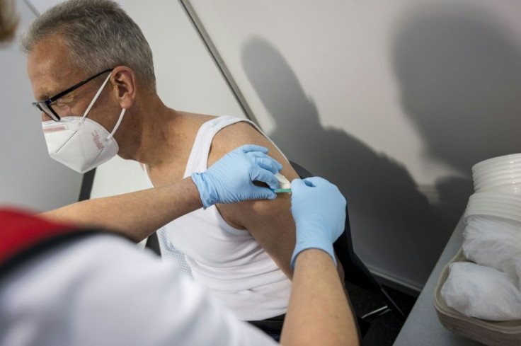 Ralf Scharf receives his vaccination at a centre set up in speciality chemicals company Evonik in Hanau