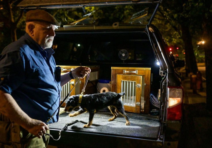 Richard Reynolds of the Ryder's Alley Trencher-fed Society (R.A.T.S.) takes his dog out of a crate in lower Manhattan on May 14, 2021