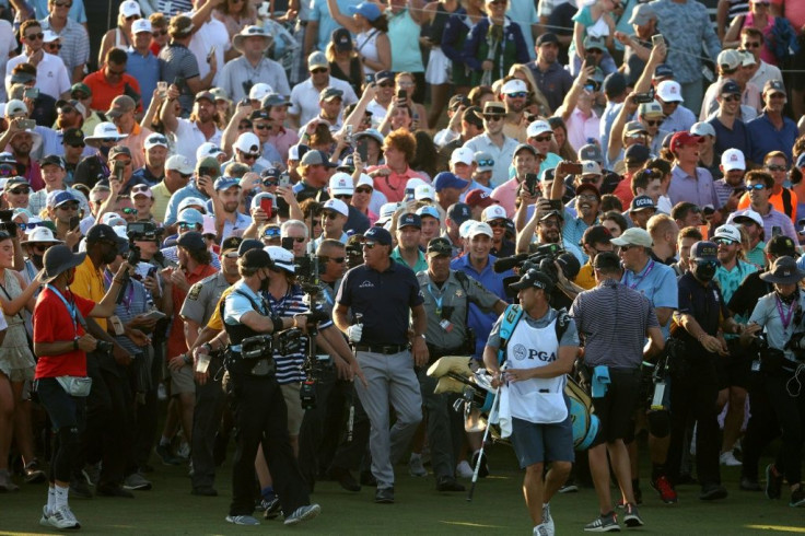 Phil Mickelson is cheered on by fans as he walks to the 18th green on the way to victory in the 2021 PGA Championship at Kiawah Island, South Carolina