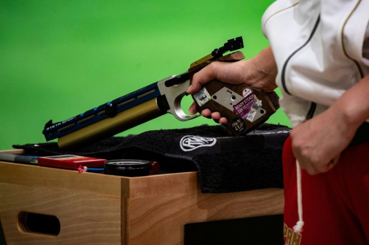 An athlete competes at a shooting test event for the Tokyo 2020 Olympics. Japan's tough gun-control laws are posing unusual problems at the Games, from the coach who can't touch a firearm to strict limits on ammunition