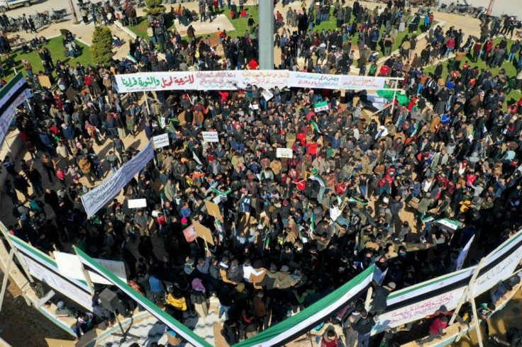 An aerial view shows displaced Syrians demonstrating against President Bashar al-Assad and the upcoming presidential election in the rebel-held city of Idlib on February 19, 2021