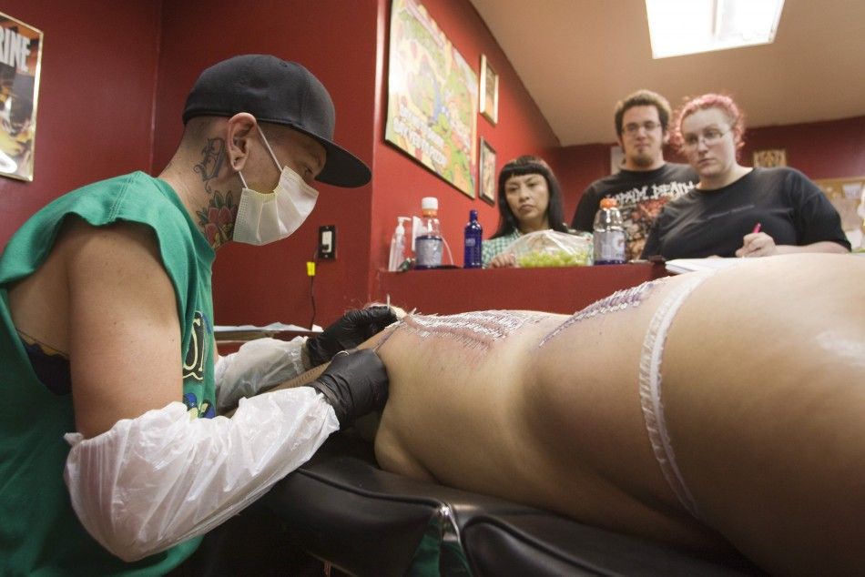 Body piercer Bill quotDangerquot Robinson pierces the back of sideshow performer Staysha Randall during an attempt to break the Guinness Book record in Las Vegas