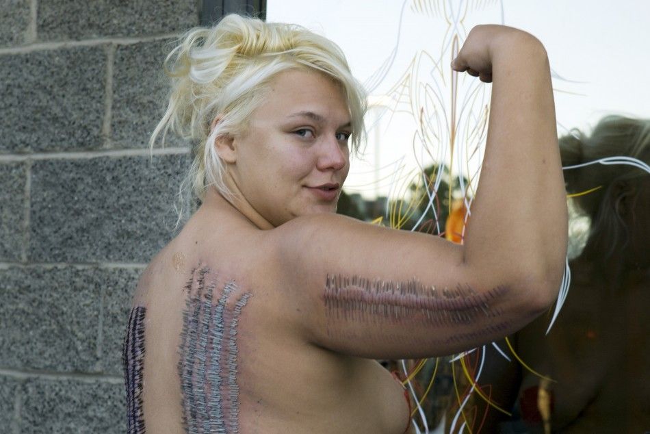 Sideshow performer Staysha Randall poses outside Inktoxicated Tattoos after breaking the Guinness Book record in Las Vegas