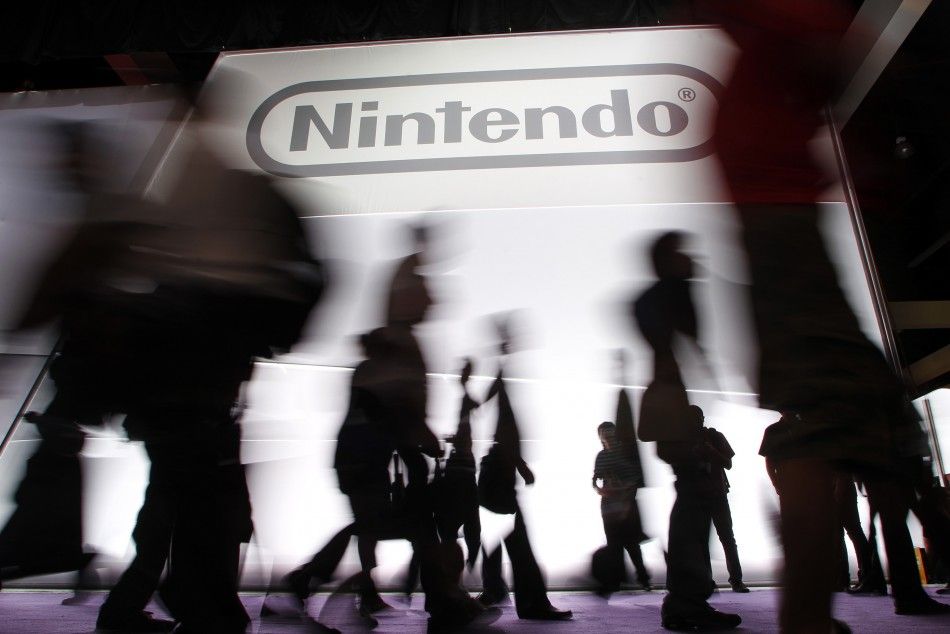 Attendees walk past the Nintendo of America Inc. booth during the Electronic Entertainment Expo or E3 in Los Angeles June 7, 2011.