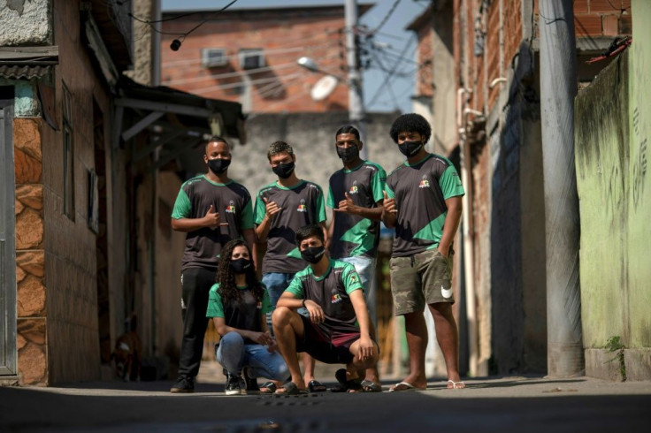 AfroGames e-sports team members (L-R) Joao Barbosa, 17, Daniel de Paula, 19, Ronald Nascimento, 19, Yuri Souza, 20, Gabriela Ferreira, 19, and Thiago Pestana, 21, pose for a picture at the Vigario Geral favela