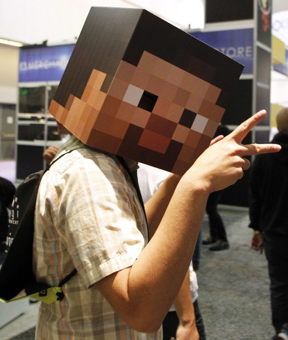 An attendee wears a video game cardboard face as he walks the floor of the the Electronic Entertainment Expo or E3 in Los Angeles June 7, 2011.