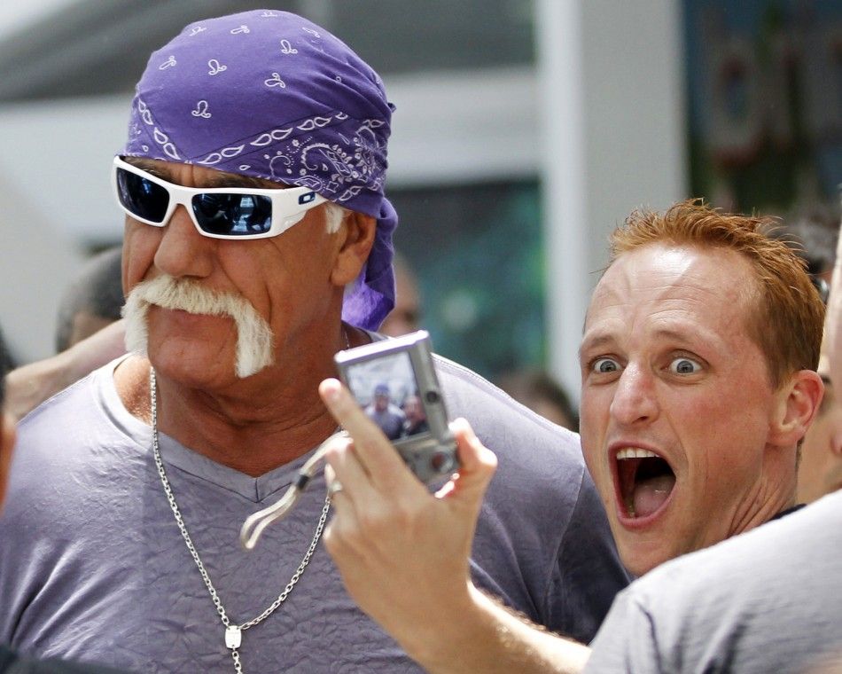 A fan takes a photo with wrestler Hulk Hogan as he walks in the Los Angeles Convention Center while on site to promote Majesco Entertainment039s quotHulk Hogan039s Main Eventquot video game on Kinect for Xbox 360 during the Electronic Entertainm