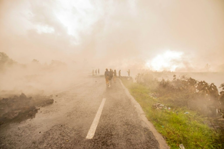 Residents on Sunday walked through the smoke from the smouldering lava