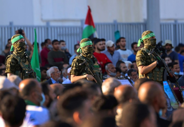Members of Al-Qassam Brigades, the armed wing of the Hamas movement, attend a rally in Gaza City on May 24