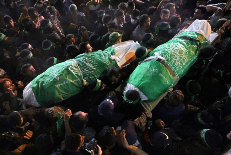 Palestinians carry the bodies of members of the Hamas military wing, who were reportedly killed in Israeli bombardment of a tunnel, during a funeral procession in Khan Yunis, in the southern Gaza Strip