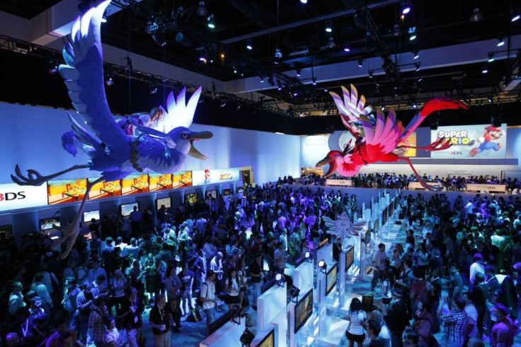 Attendees walk at the Nintendo booth during the Electronic Entertainment Expo, or E3, in Los Angeles June 7, 2011.