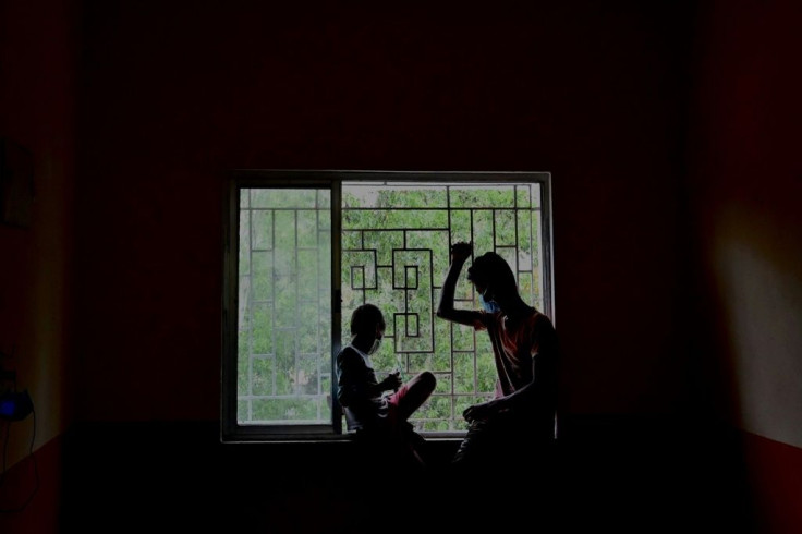 Villagers wait at a shelter as Cyclone Yaas barrels towards India's eastern coast in the Bay of Bengal