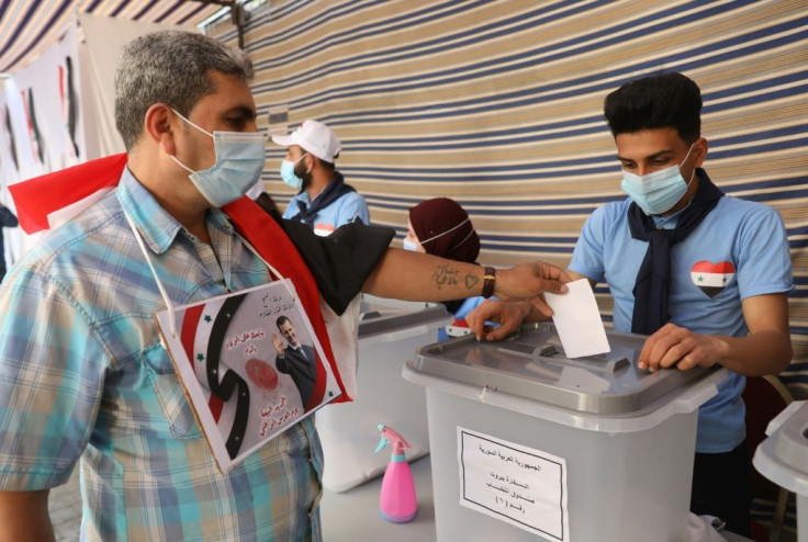 Some Syrians abroad already voted last week; in this May 20 photograph a Syrian in Lebanon, casts a ballot in Beirut. But Syrians who fled the country illegally -- and so who could not show an exit stamp in their passport -- were barred from voting